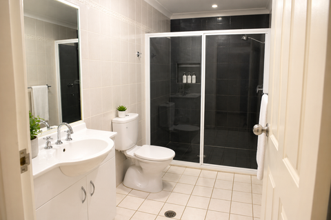 Modern ensuite with dual vanity, black and white tile, large walk-in shower